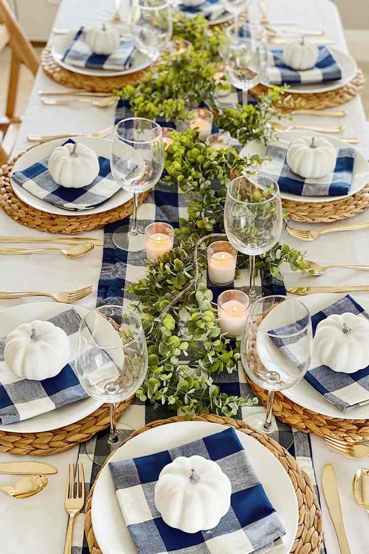 Autumn decoration in a modern country house style with checked napkins made of fabric and table runner