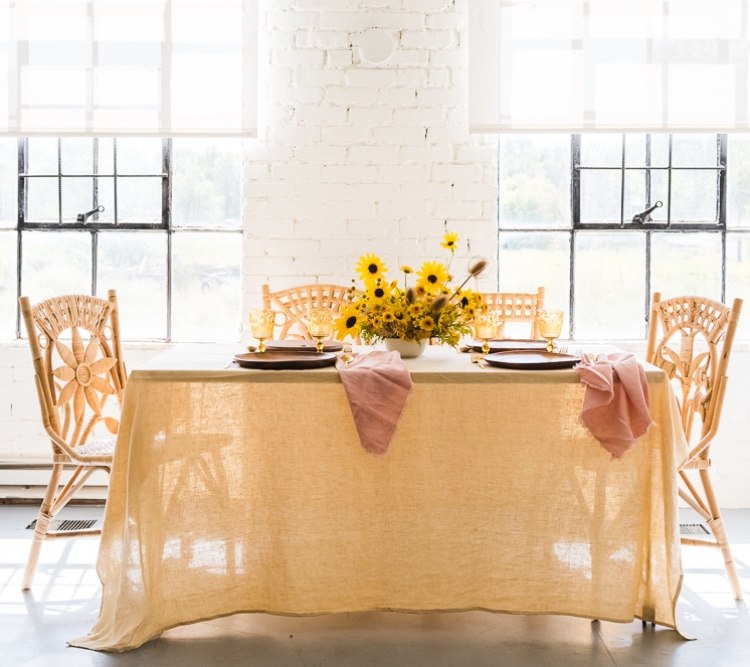 Autumn decoration with sunflowers and a yellow linen blanket