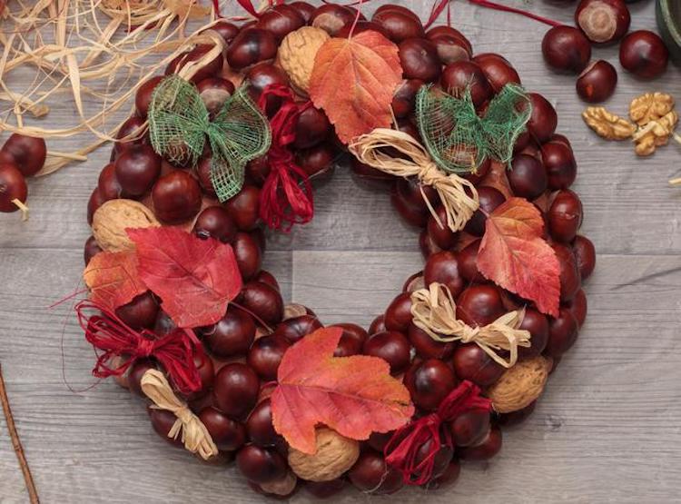 Autumn wreath with chestnut raffia bows and red leaves