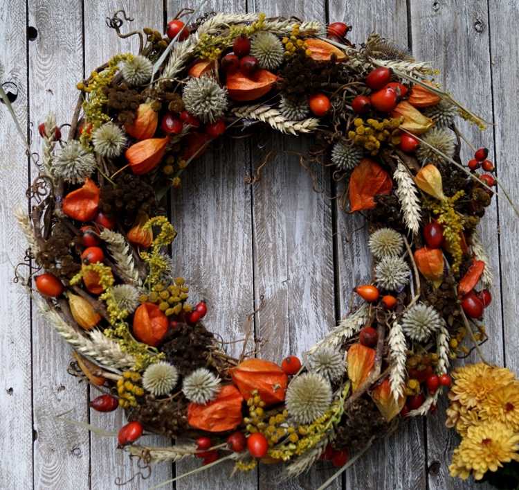 Autumn wreath with physalis thistles and dried flowers