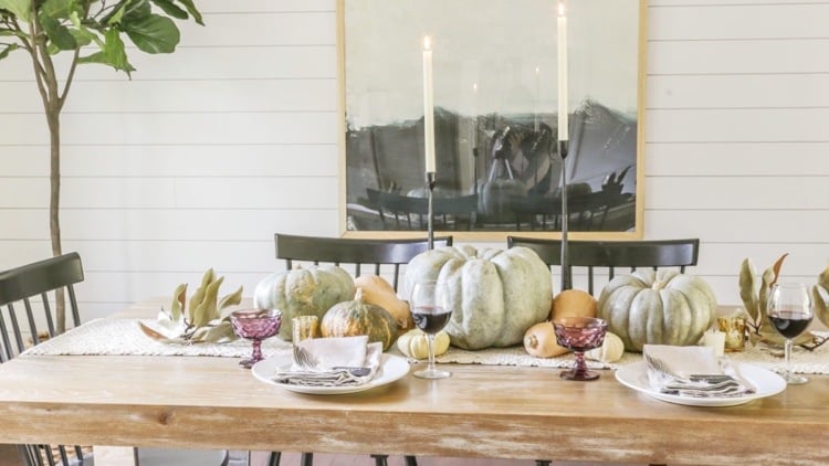 Pumpkins and bay leaves as a puristic table decoration in autumn