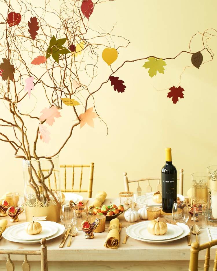 Modern autumn decoration with fir branches and autumn leaves made of cardboard