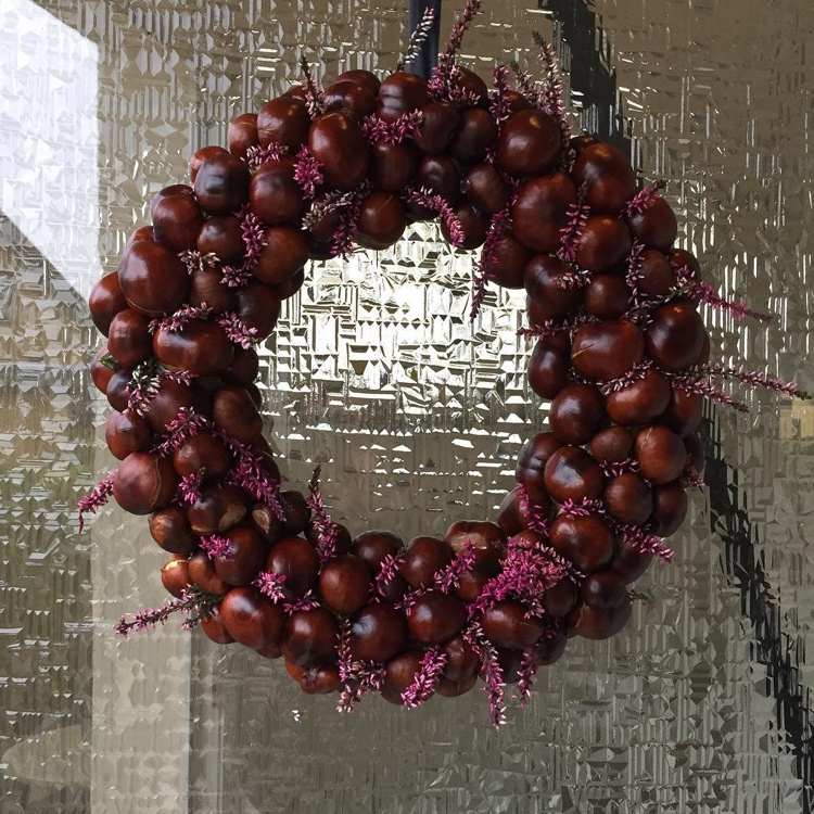 Door wreath with chestnuts and heather branches