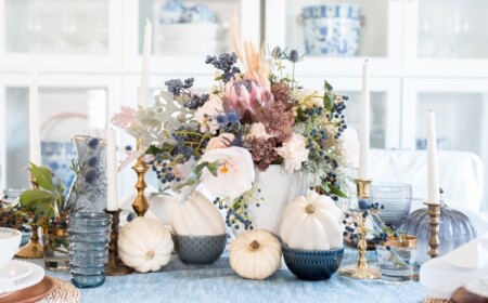 Vintage Herbstdeko Tisch mit weißen Kürbissen und blauen und rosa trockenen und frischen Blumen