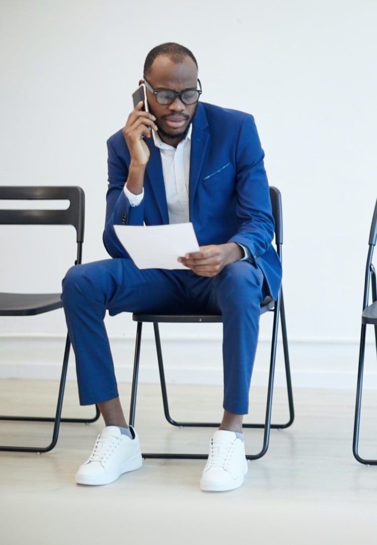 blue suit with white shirt and white sneakers looks business casual