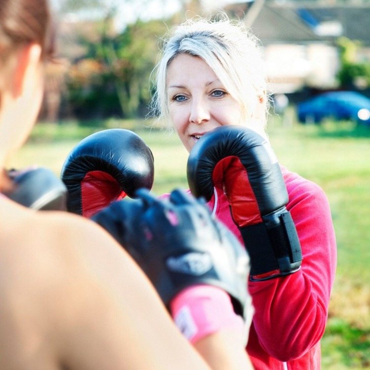 motivierte frau beim training für kickboxen oder boxen kalorien verbrennen