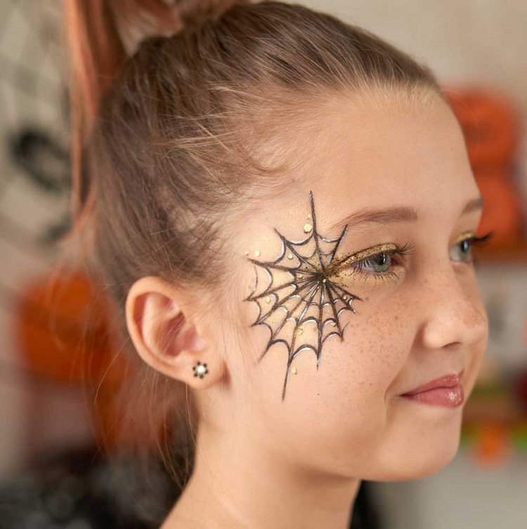 elegantes Kinderschminken zu Halloween Spinnennetz schwarz und gold