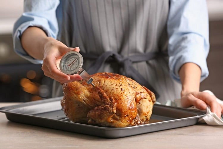 Use a meat thermometer to determine when the roast chicken is ready