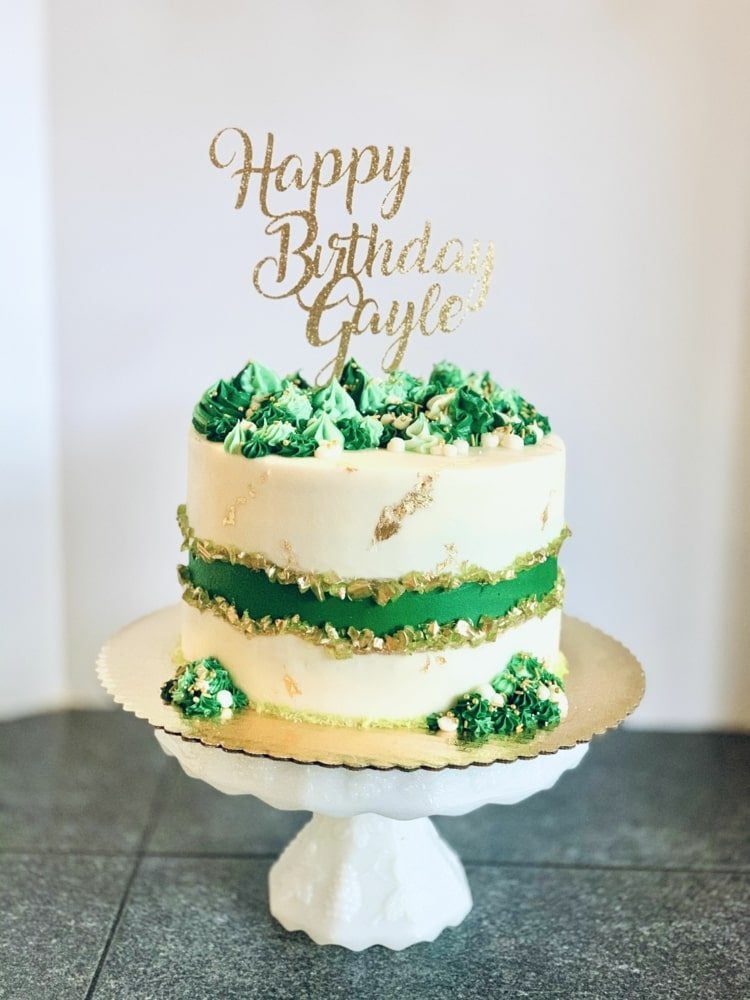 Grüne Geburtstagstorte mit Spritzbeutel und Tülle dekoriert
