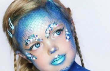 Meerjungfrau schminken für Kinder in blauen Farben und mit Schuppen und Glitzersteinen