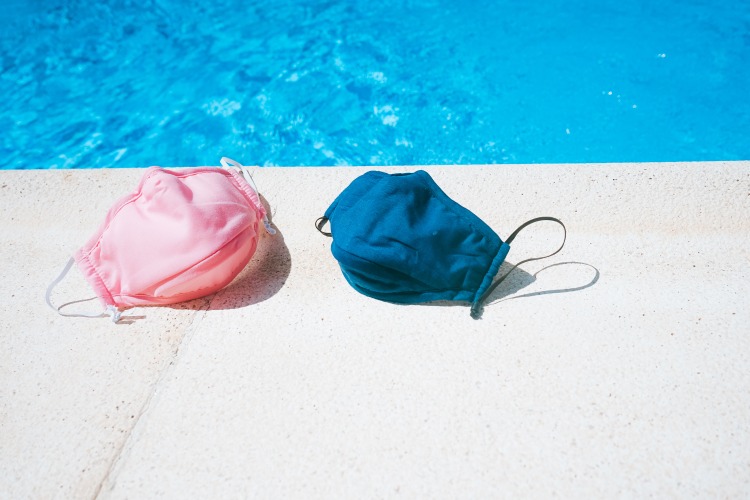 ausgezogene schutzmasken gegen covid 19 aufgrund von niedrigem ansteckungsgefahr im pool