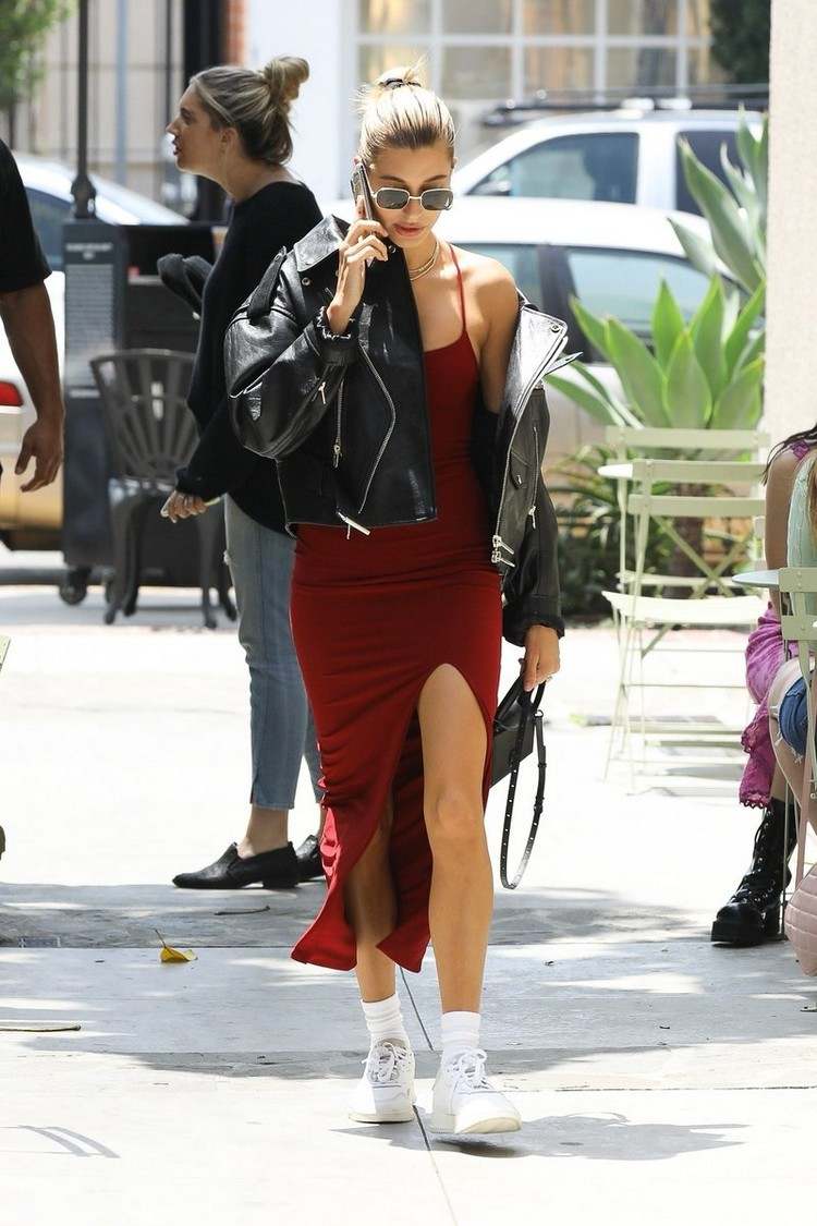 Hailey Bieber rotes Slip Dress weiße Sneaker und Socken und Lederjacke