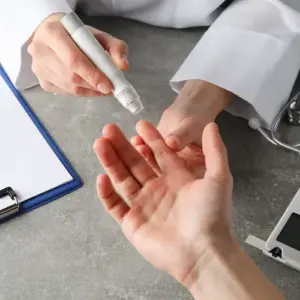 arzt untersucht patient auf insulineristenz bei prädiabetes mit blutzuckermessgerät
