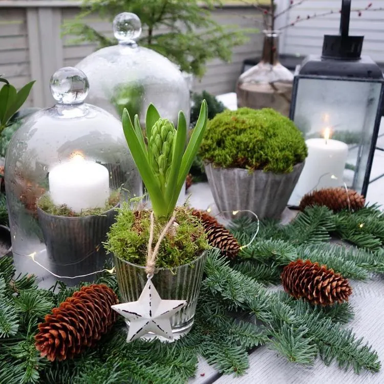 Gartentisch winterlich dekorieren mit Kerzen unter Glasglocken
