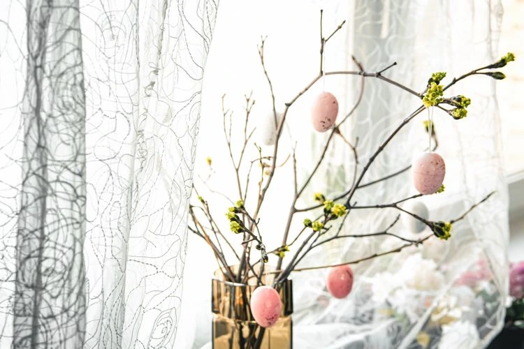 Osterbaum mit dekorativen Eiern auf der Fensterbank
