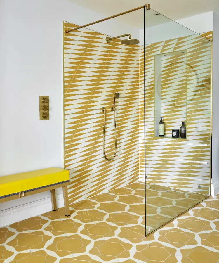 shower area designed in yellow with tiles and bench