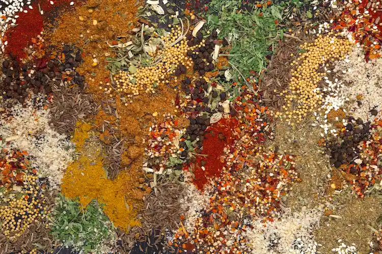 various spices like red and black pepper in a colorful mix