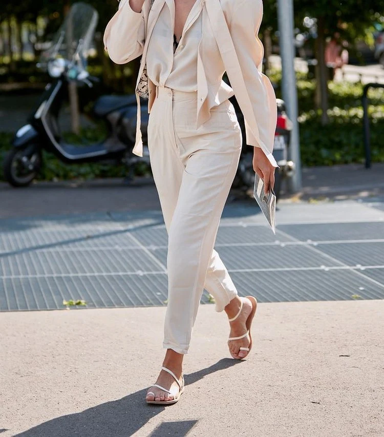 In Kombination mit einem Blazer verleihen weiße Sandalen der formellen Kleidung einen legeren Look