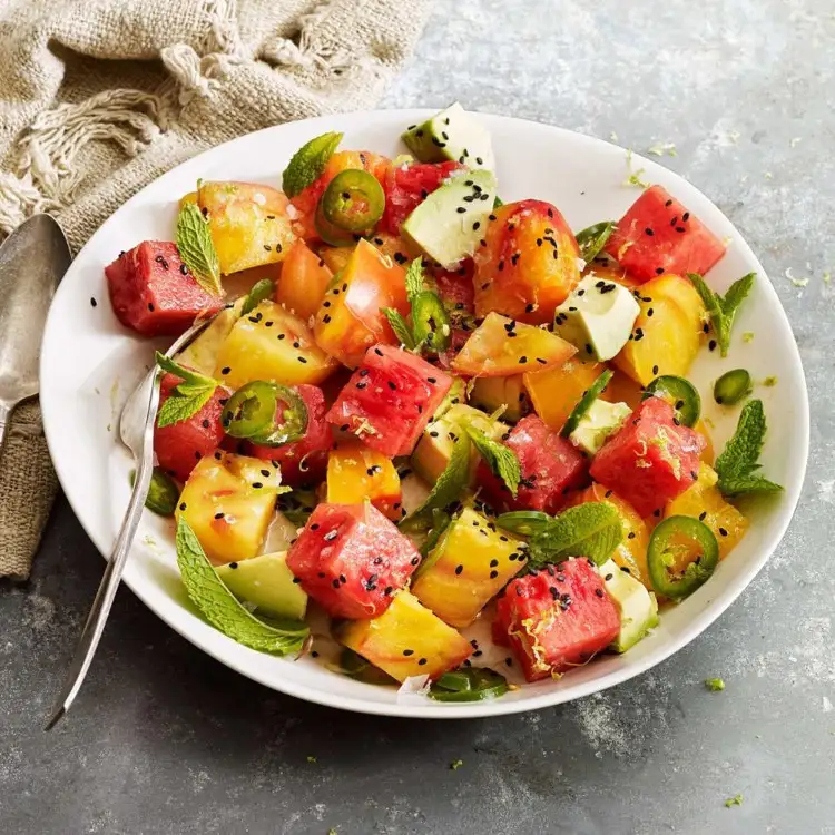 Make a summer salad with tomatoes, watermelon and avocado