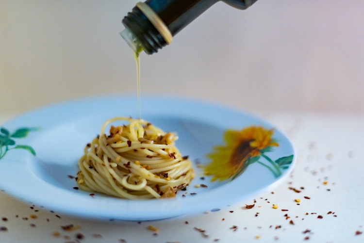 Add extra virgin olive oil to the classic spaghetti aglio e olio recipe