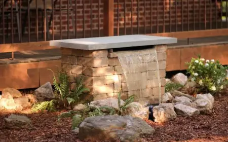 naturstein oder beton als materialien für den bau von brunnen mit wasserfall im garten verwenden