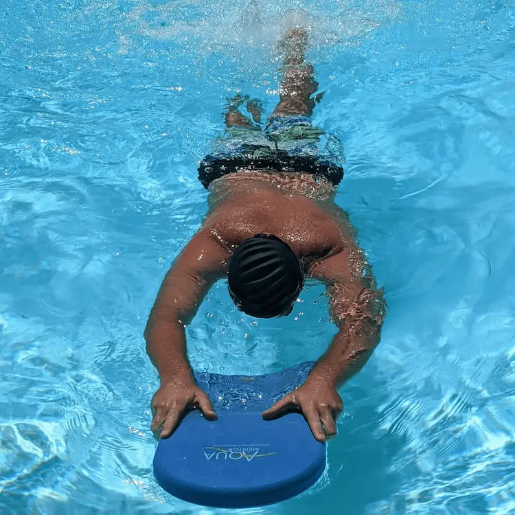 Hold the edge of the pool or grab the kicking board