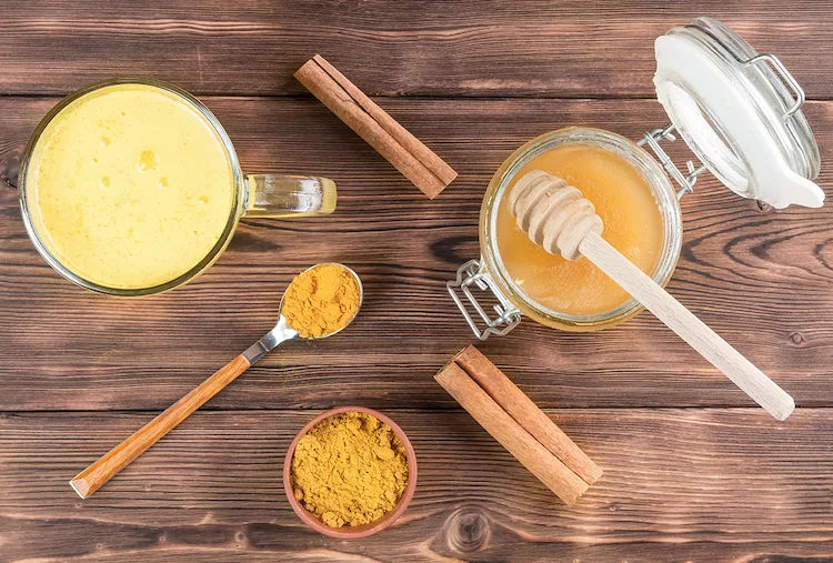 naturprodukte wie honig und kurkuma können mit als hausmittel in warmen getränken schleim im hals lösen