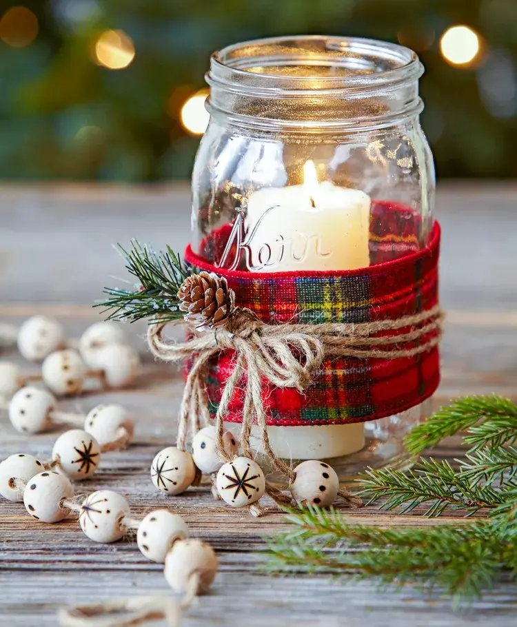 typische Weihnachtsdeko mit Kerze und Karostoff im Glas