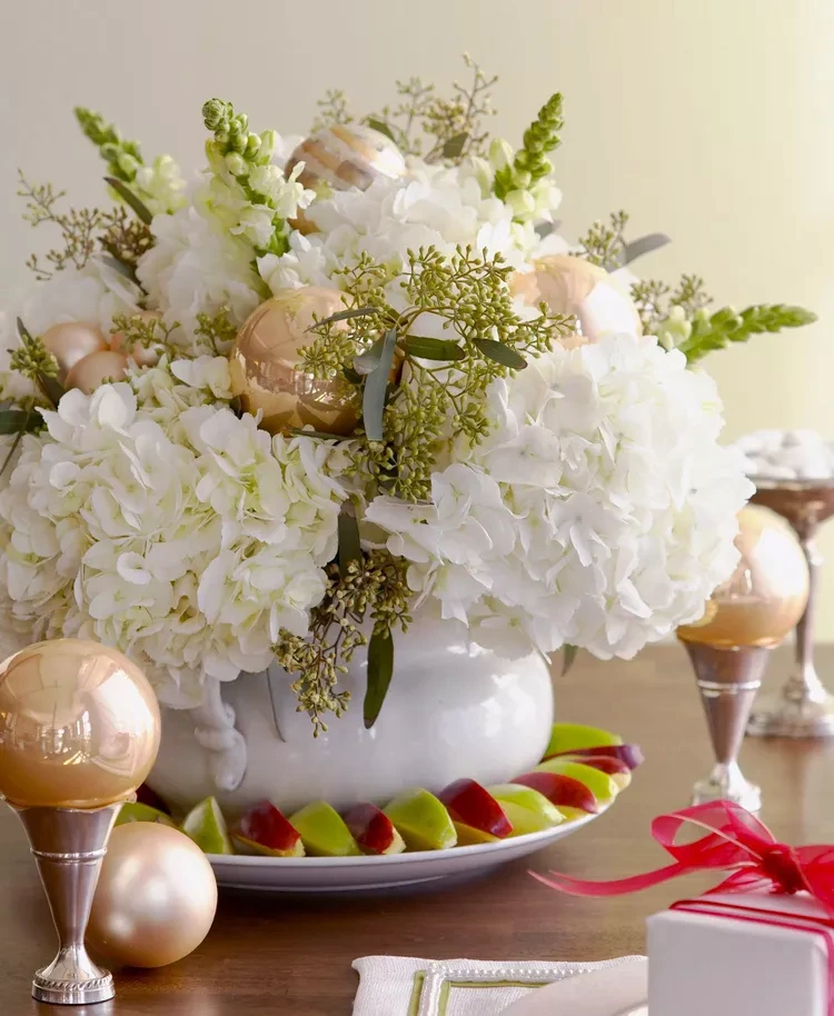 Umrunden Sie ein Mittelstück aus rein weißen Blumen mit einem Rand aus grünen und roten Apfelspalten