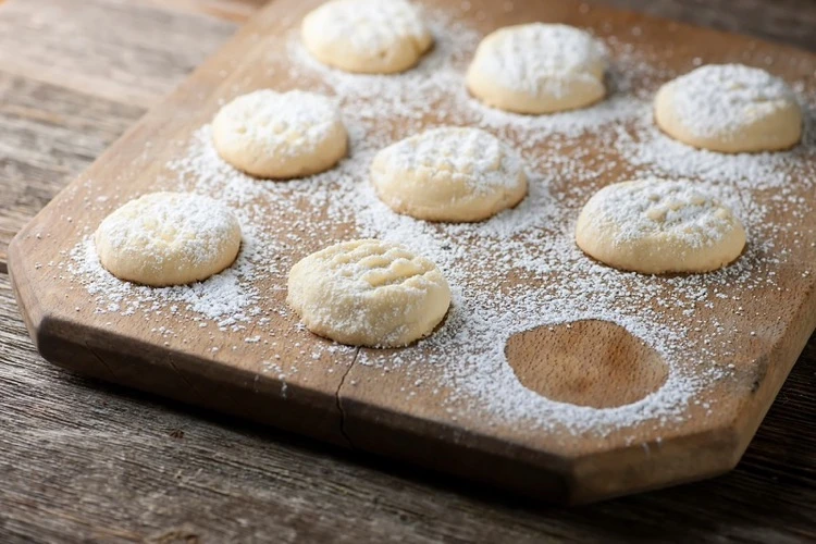 Bake delicate vanilla cookies with powdered sugar for Christmas