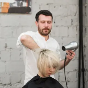 einen modernen kurzen haarschnitt beim friseur machen lassen und selbstbewusst blonde haare tragen