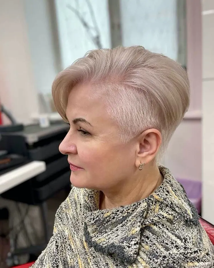 Platinum blonde short haircut with undercut and side parting