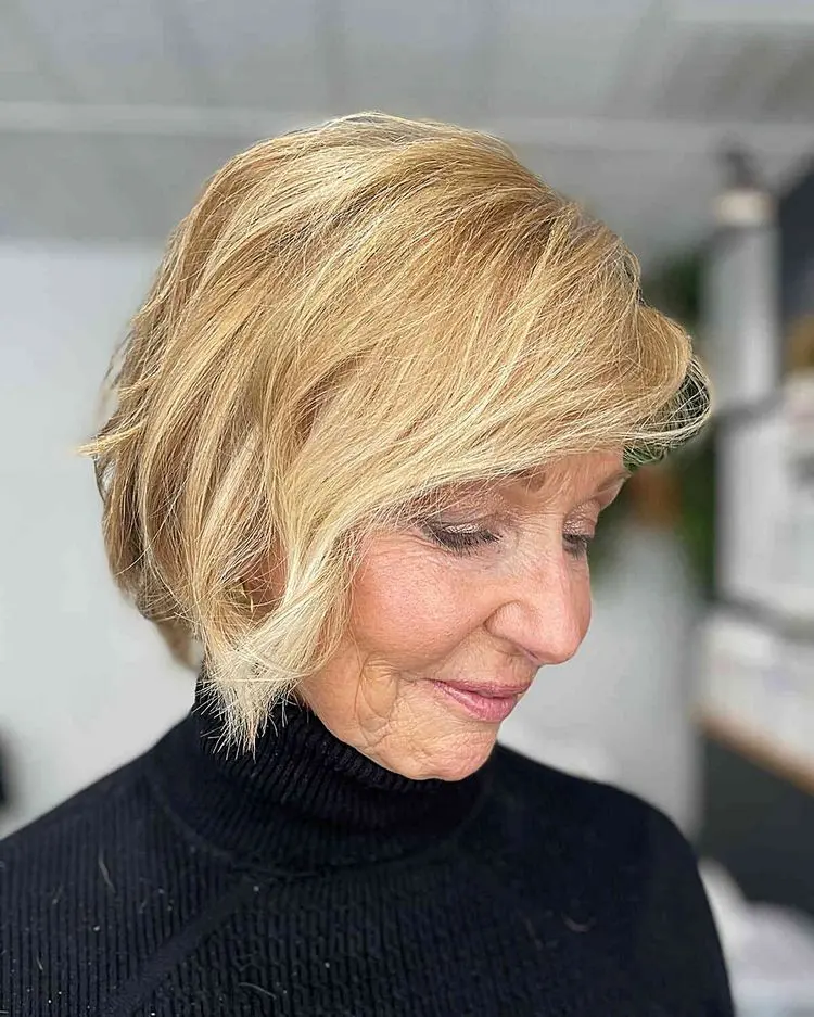 Choppy bob with side bangs for older women with blonde hair