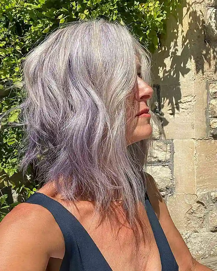 Silver choppy bob with purple highlights for older women