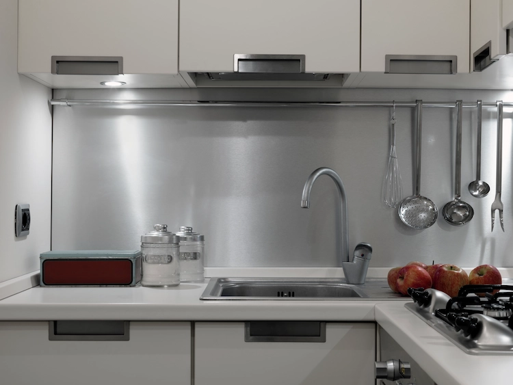 dezent beleuchteter kleiner kochbereich mit modernen küchenschränken als praktische lösung