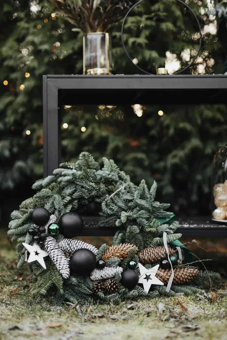weihnachtskranz mit schmuck und zapfen als deko für draußen zum advent