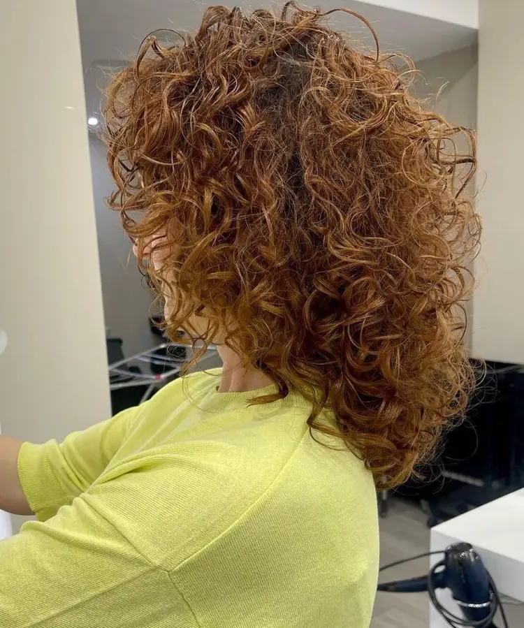 An example of a round cut for women with medium length curly hair