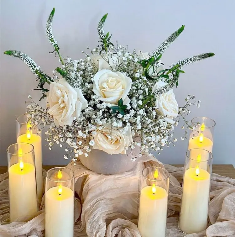 A beautiful christening celebration arrangement is white with roses, gypsophila and snowwort