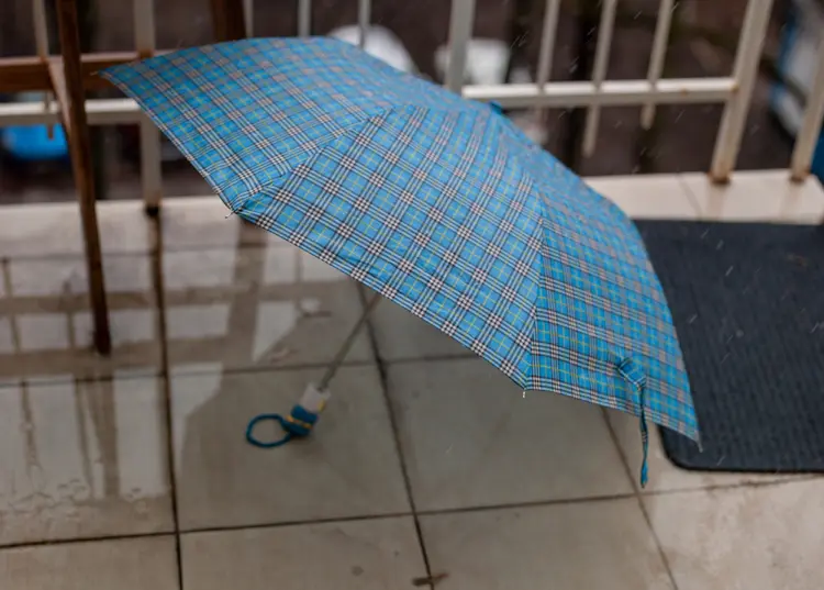 regenwasser mit regenschirm auffangen auf balkon