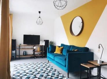 Wände hinter dem Sofa in Akzentwände verwandeln mit einem großen, gelben Dreieck