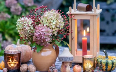 Warme Holztöne, Walnüsse, Hortensien und rote Beeren in einer Vase