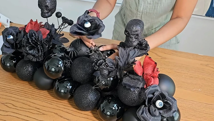 Halloweendeko basteln mit Schwimmnudeln - Tisch mit Christbaumkugeln schmücken