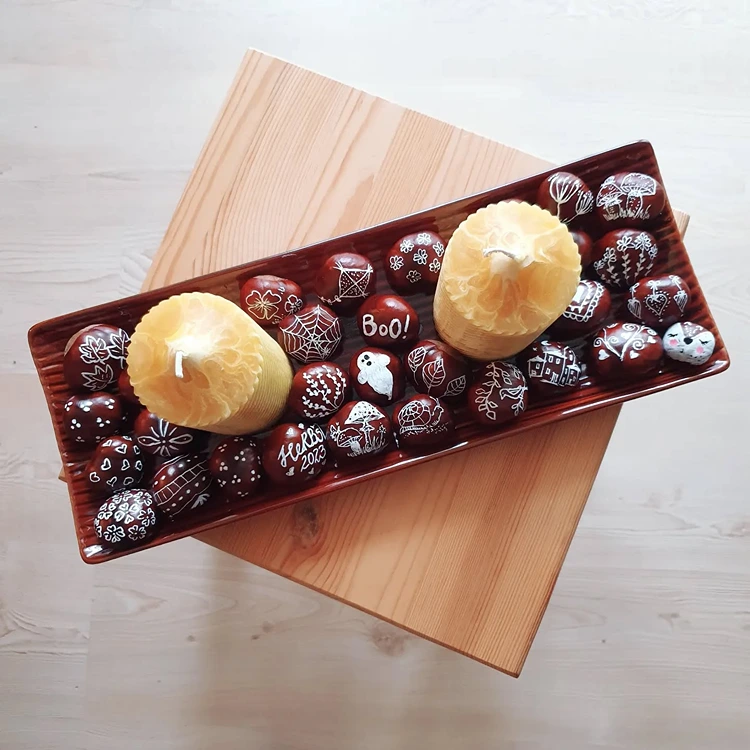 herbstdeko basteln aus kerzen und kastanien