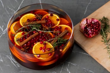 festive,punch,bowl,filled,with,oranges,,pomegranate,seeds,,and,spices