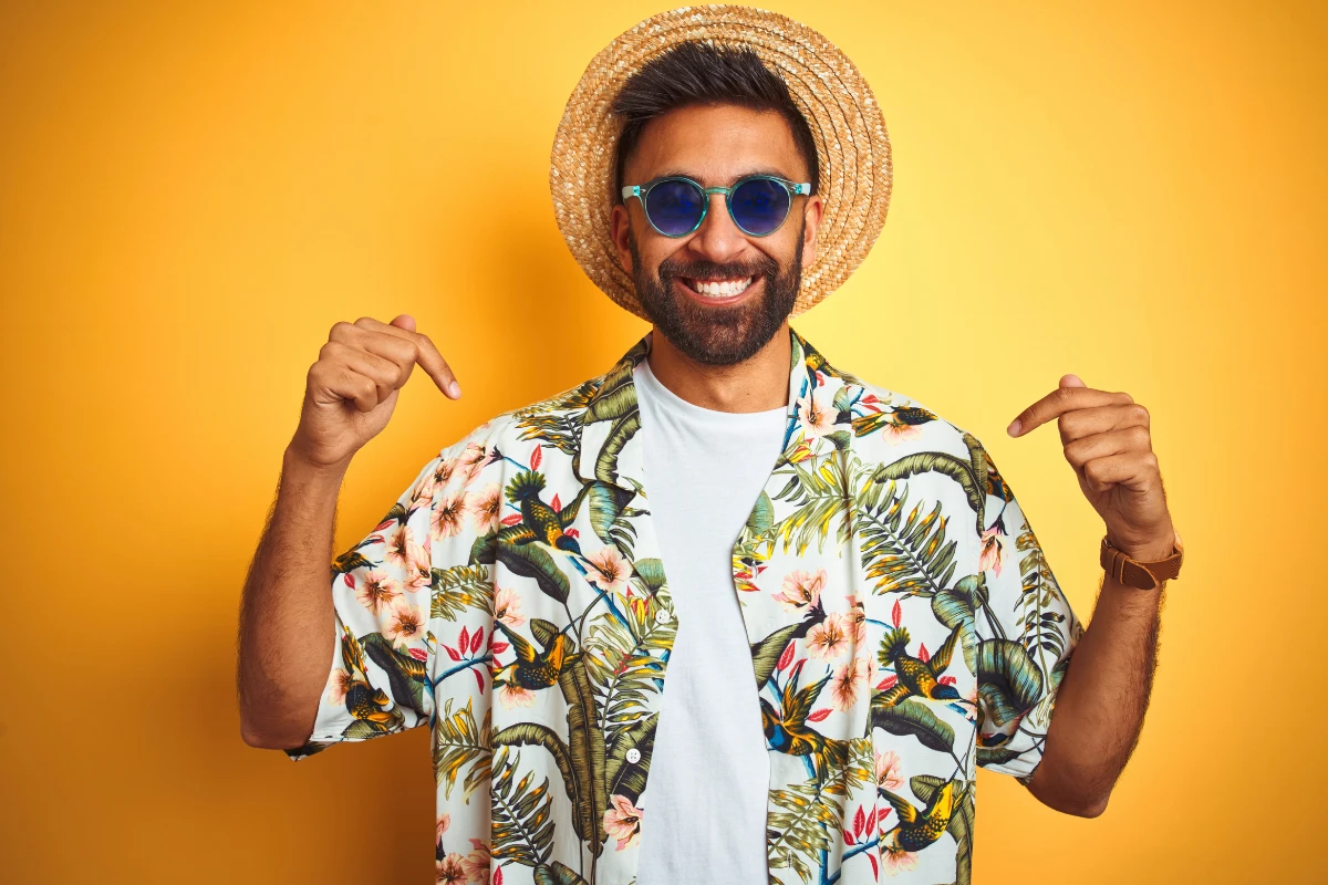 mann mit blumenhemd, weißem t shirt und sommerhut
