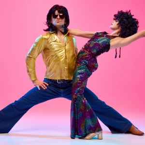 mann und frau in hellen retro kostümen in tanzposse 70er jahre sommer outfits