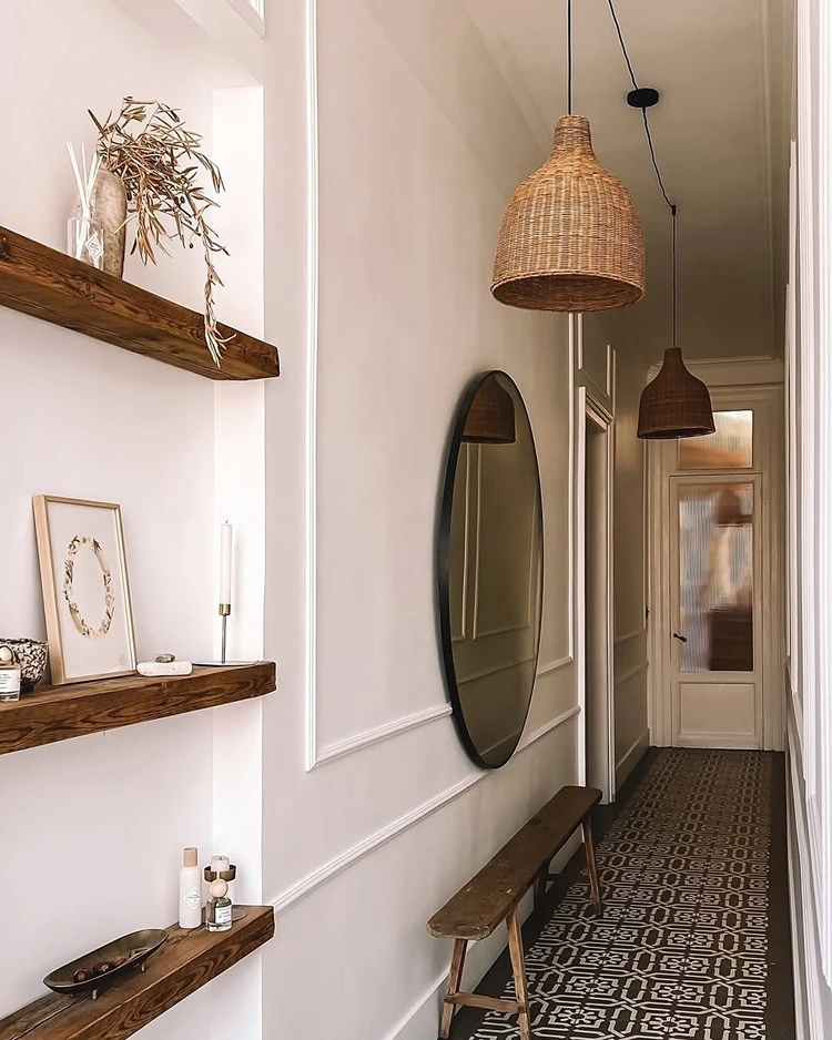 Stylische Flurgestaltung mit gemustertem Läufer, schmaler Sitzbank und rundem Spiegel