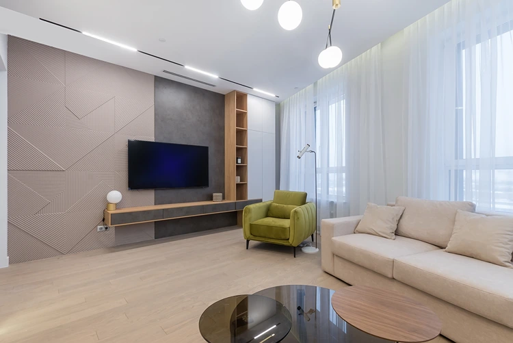 wohnzimmer mit tv wand in beton optik und geometrischer struktur