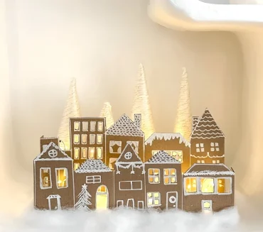 Das Winterdorf mit einer Lichterkette beleuchten