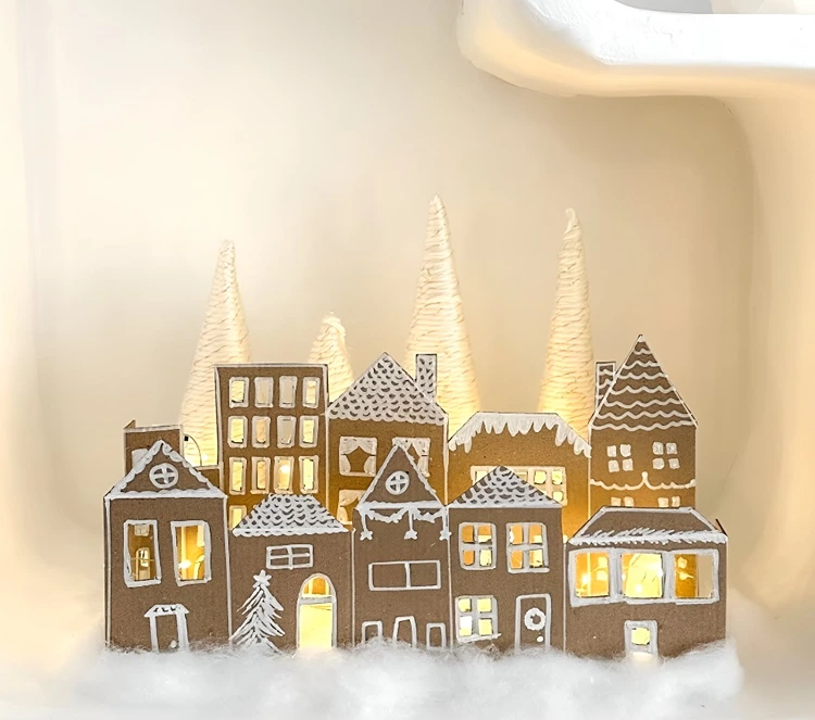 Das Winterdorf mit einer Lichterkette beleuchten